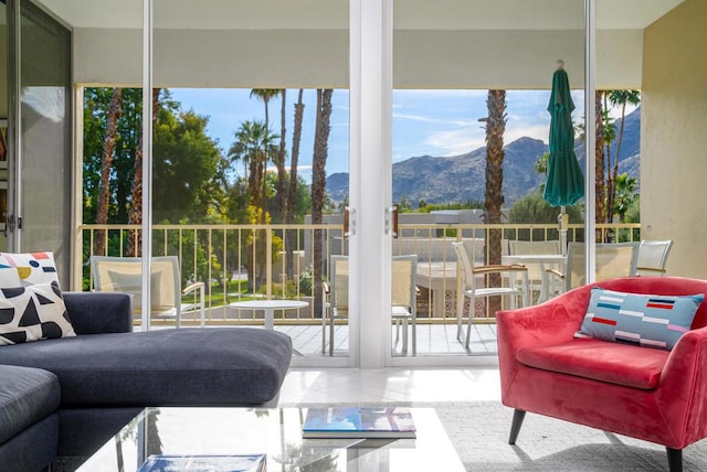 sunroom featuring a wealth of natural light and a mountain view