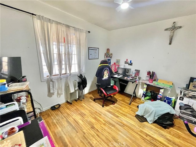 home office with ceiling fan and hardwood / wood-style flooring