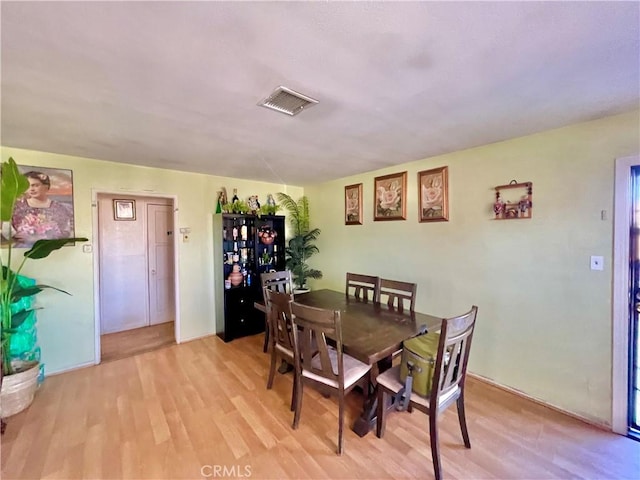 dining space with light hardwood / wood-style flooring