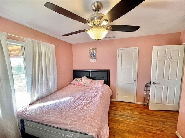 bedroom with ceiling fan and light hardwood / wood-style floors