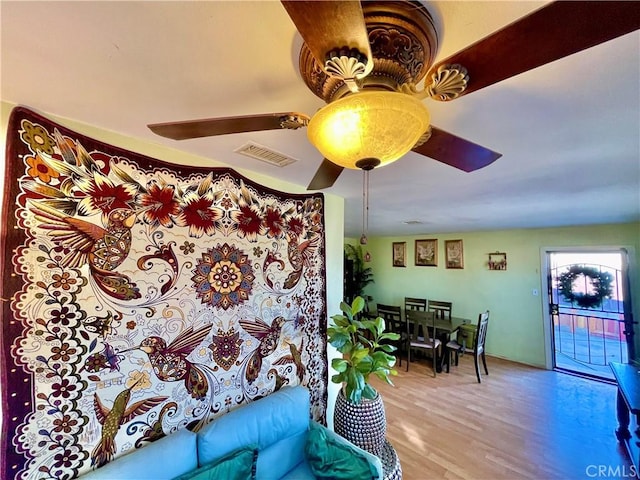 living room with light hardwood / wood-style floors and ceiling fan