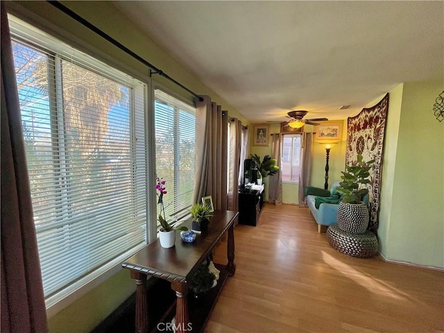 corridor with light hardwood / wood-style floors