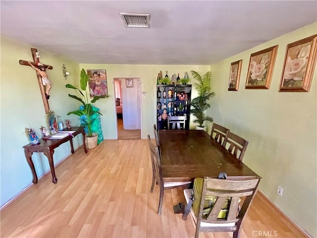 dining area with light hardwood / wood-style floors