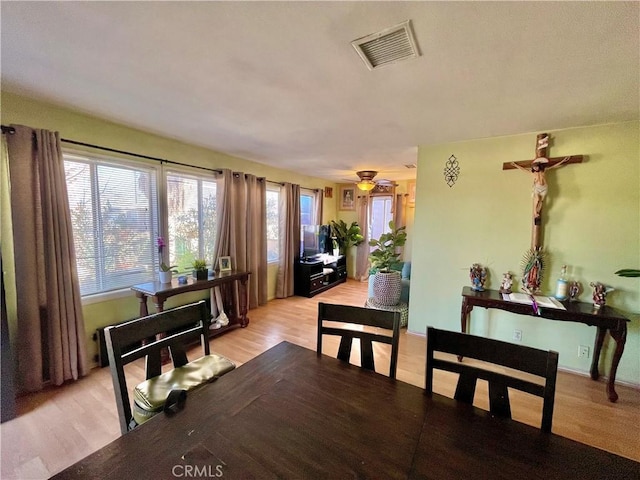 dining area with ceiling fan and light hardwood / wood-style floors