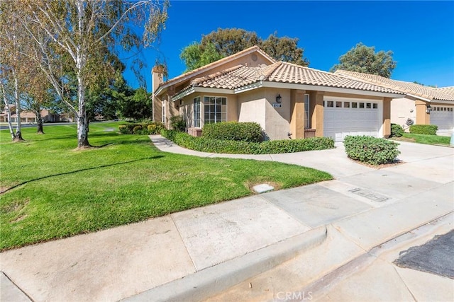 view of front of property with a front yard and a garage