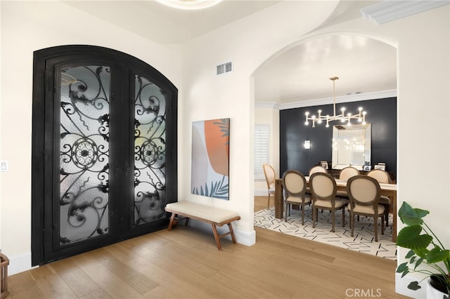 entrance foyer with hardwood / wood-style flooring and a chandelier