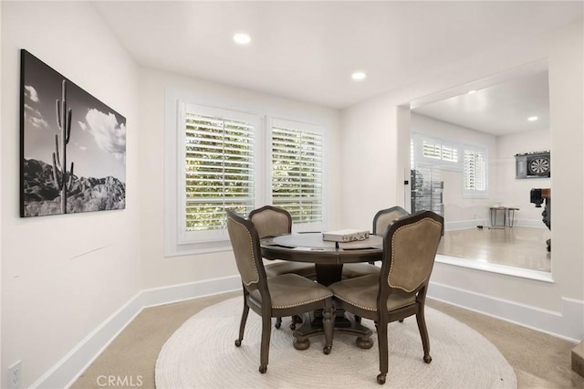 dining room with light colored carpet