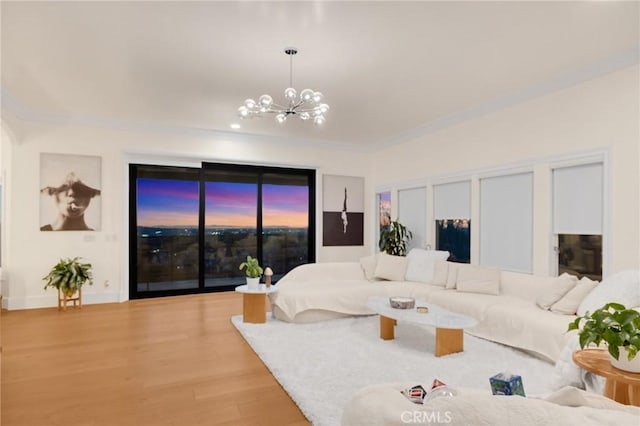 living room featuring a chandelier, crown molding, and hardwood / wood-style flooring