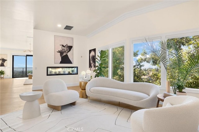 interior space featuring ornamental molding, hardwood / wood-style floors, and multiple windows