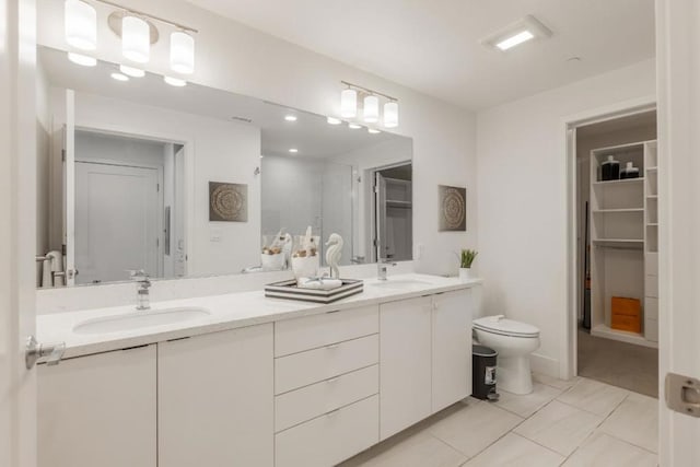 bathroom featuring tile patterned floors, vanity, and toilet