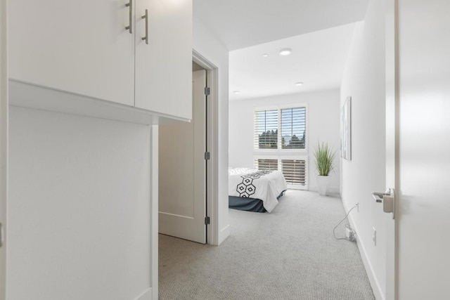 hallway featuring light carpet