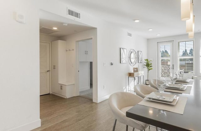 dining space featuring light wood-type flooring