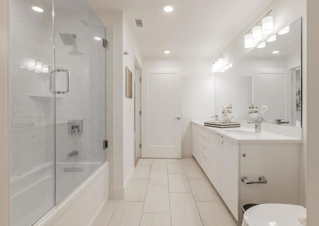 full bathroom featuring bath / shower combo with glass door, toilet, tile patterned floors, and vanity