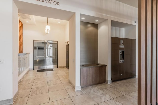 hallway with an inviting chandelier and elevator