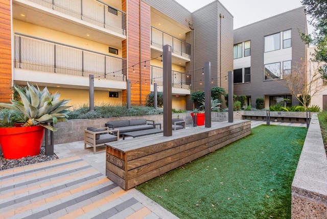 view of property's community with an outdoor hangout area and a patio area