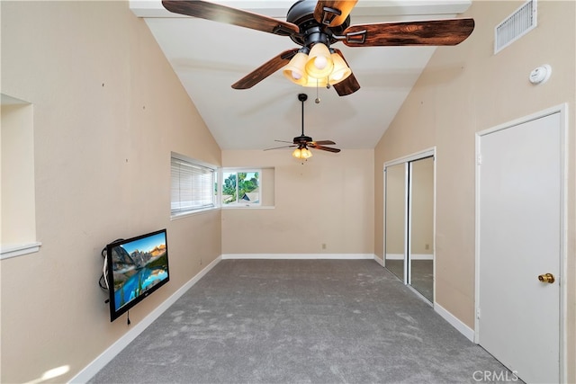 unfurnished living room featuring high vaulted ceiling, ceiling fan, and dark carpet