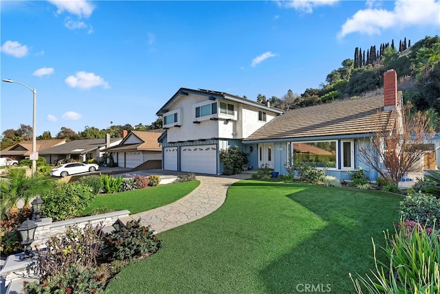 view of front of house with a garage and a front yard