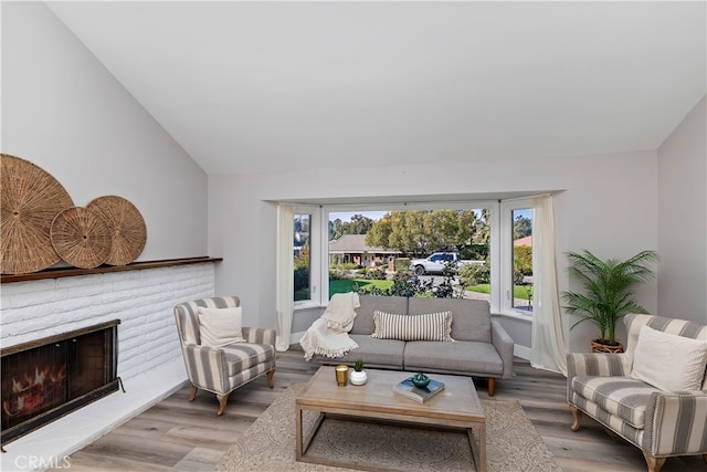 living room with hardwood / wood-style flooring and lofted ceiling