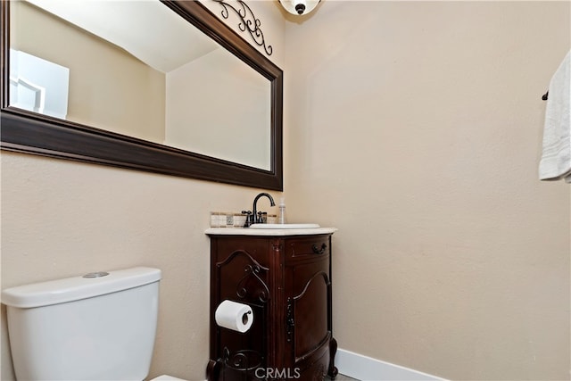 bathroom with toilet and vanity