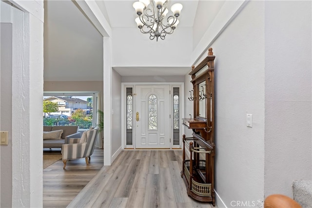 foyer featuring a notable chandelier and light hardwood / wood-style floors