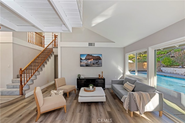 living room featuring wood-type flooring and lofted ceiling with beams