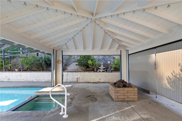 view of patio featuring a pool with hot tub