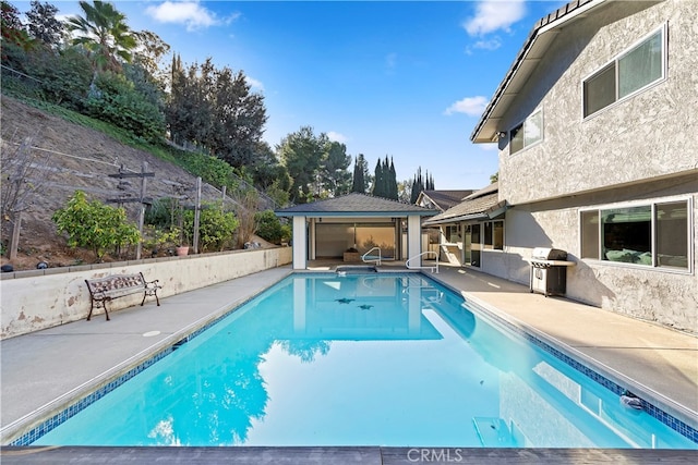 view of pool featuring a patio area, a gazebo, and a grill