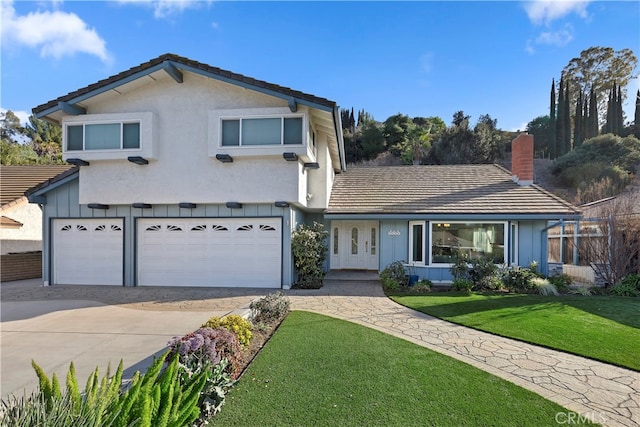 view of front property with a front yard and a garage