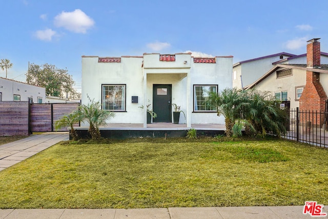 mediterranean / spanish-style house with a front lawn