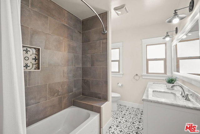 full bathroom featuring shower / bath combination with curtain, tile patterned floors, toilet, and vanity