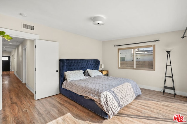 bedroom with hardwood / wood-style flooring