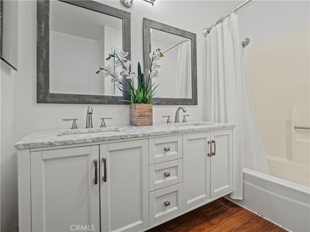 bathroom featuring vanity, shower / bath combo with shower curtain, and hardwood / wood-style floors