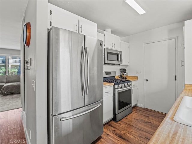 kitchen featuring white cabinets, dark hardwood / wood-style floors, and stainless steel appliances