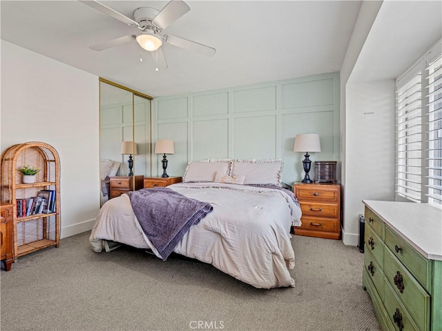 bedroom featuring light carpet, ceiling fan, and a closet