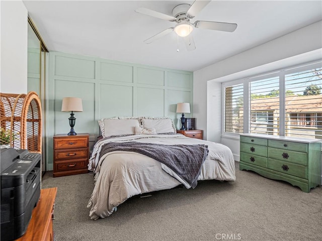 bedroom featuring ceiling fan and dark colored carpet