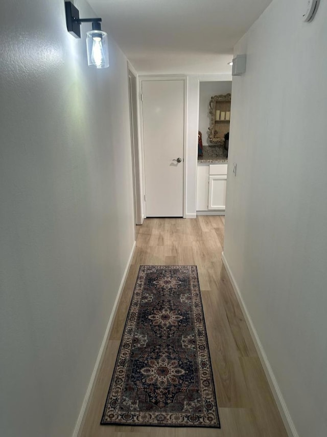 hall with light hardwood / wood-style flooring