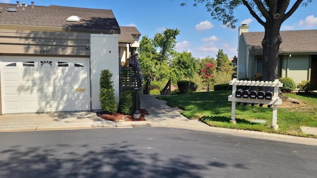 view of property exterior with a garage and a lawn