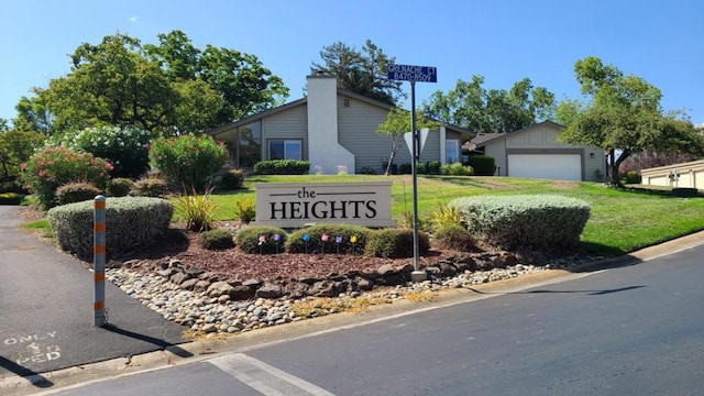 community / neighborhood sign with a lawn