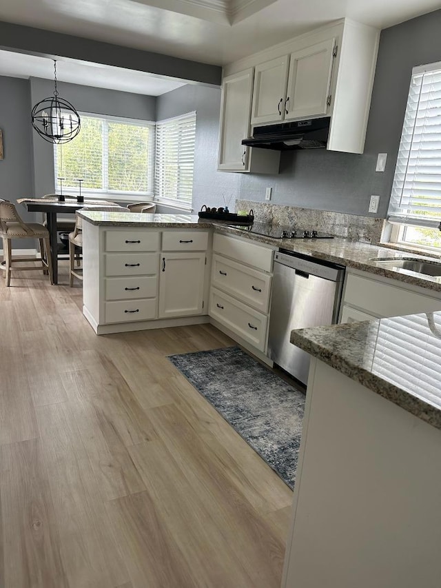 kitchen featuring white cabinets, a healthy amount of sunlight, hanging light fixtures, light wood-type flooring, and stainless steel dishwasher