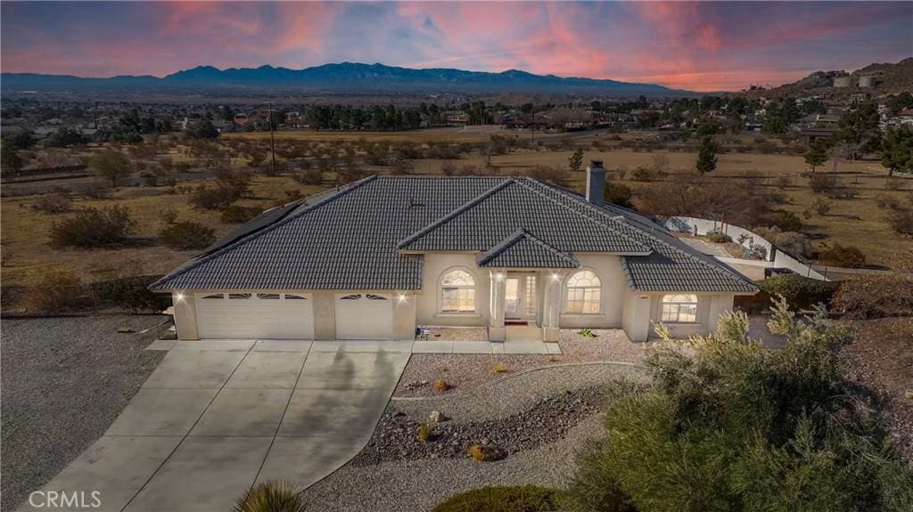 view of front of home with a mountain view and a garage