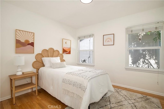 bedroom with wood-type flooring