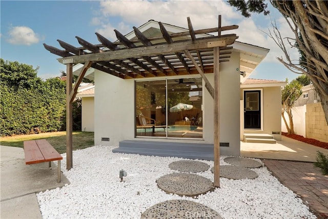 back of property featuring a pergola and a patio