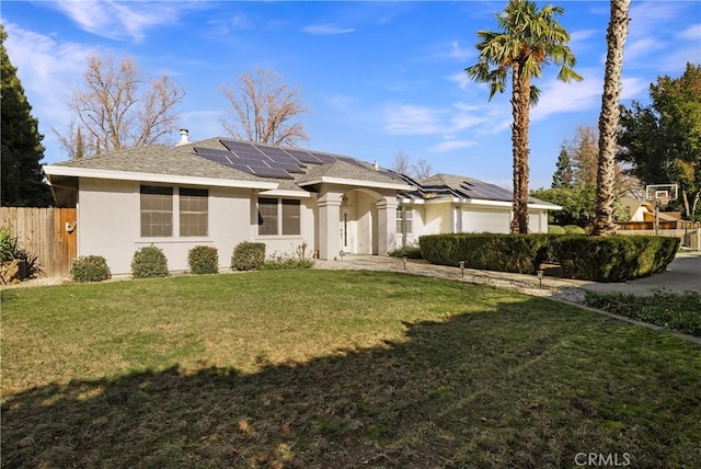 ranch-style home featuring a front lawn and solar panels