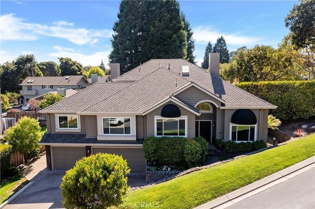 view of front of house with a front yard and a garage