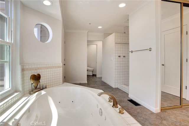 bathroom featuring plus walk in shower, toilet, crown molding, and tile patterned flooring