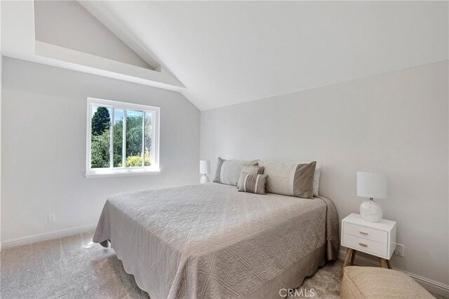 bedroom with carpet floors and vaulted ceiling