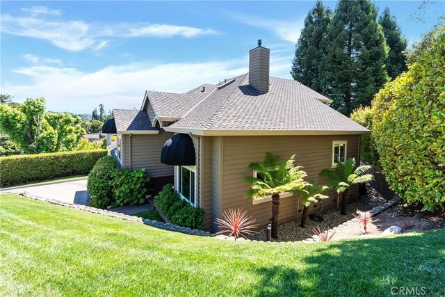 view of side of home featuring a yard