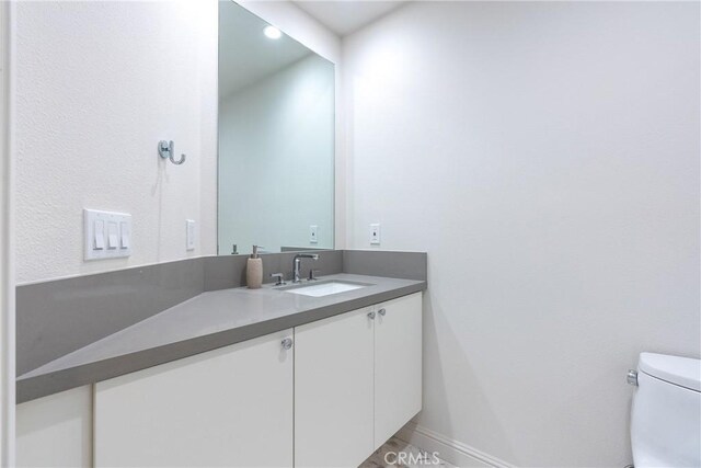 bathroom featuring toilet and vanity