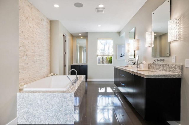 bathroom with a relaxing tiled tub and vanity