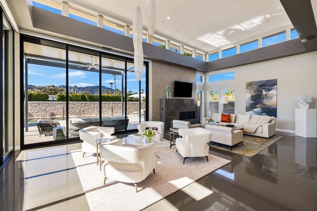 living room featuring a towering ceiling and tile patterned floors